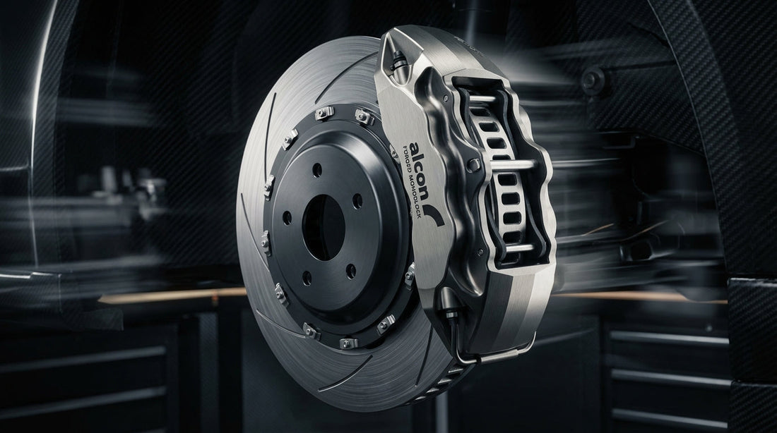 Close-up of a high-performance Alcon forged monoblock brake caliper and ventilated rotor showcasing precision automotive engineering and motorsport design.