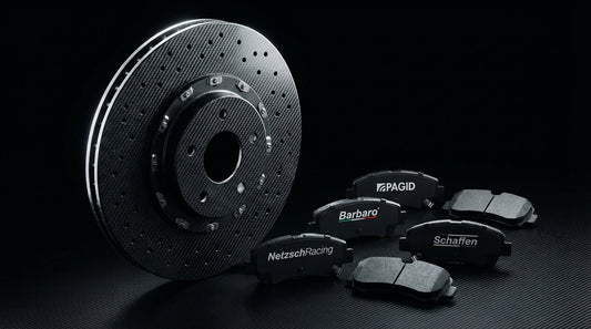 A close-up of a carbon ceramic brake rotor and high-performance brake pads from Pagid, Barbaro, NetzschRacing, and Schaffen for automotive track and street use.