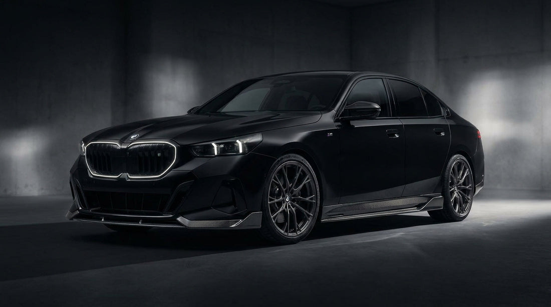 Black BMW 5 Series G60 with CMST carbon front lip and rear lip, low front three-quarter studio shot