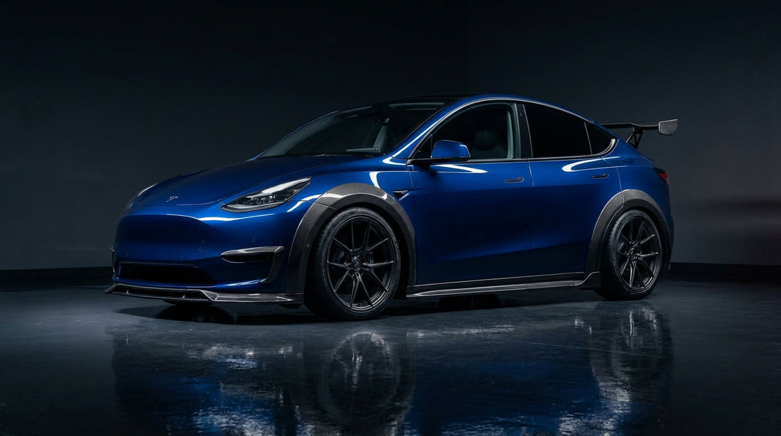 2025 Tesla Model Y Juniper widebody in deep blue with CMST carbon fibre arches, front lip and raised spoiler, 3/4 front low angle in a studio