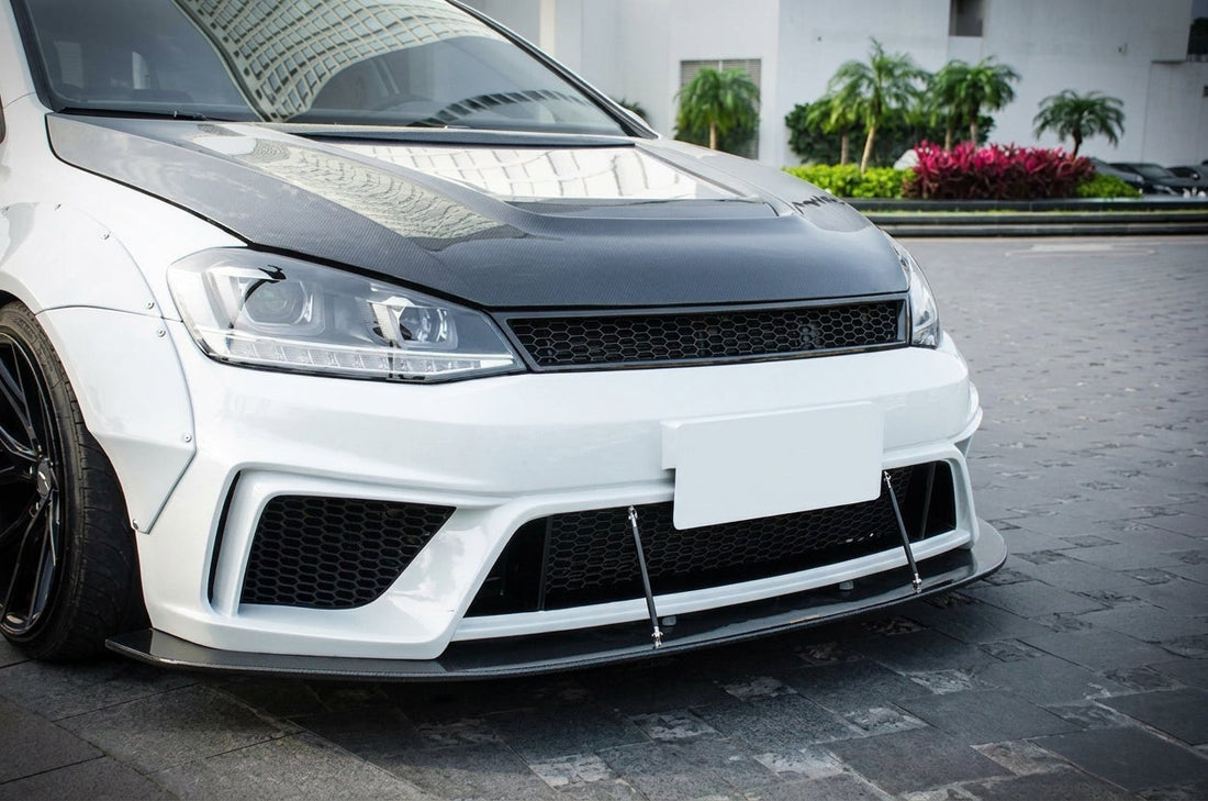 CMST Volkswagen Golf MK7 widebody in gloss white with carbon grille and arch flares, 3/4 front low angle