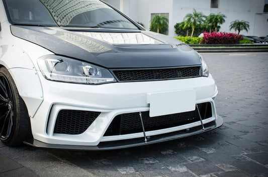 CMST Volkswagen Golf MK7 widebody in gloss white with carbon grille and arch flares, 3/4 front low angle