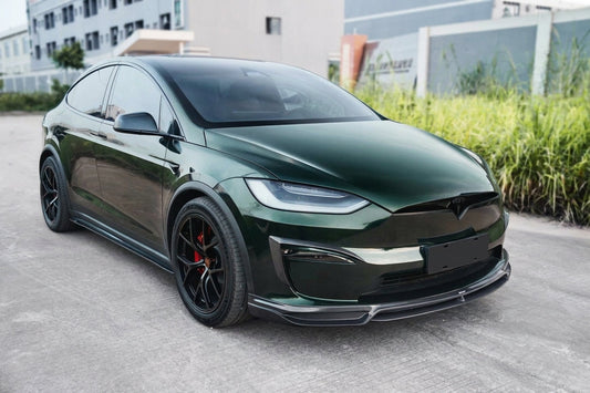 2021-2023 Tesla Model X in dark metallic green wearing the CMST widebody carbon-fibre kit, 3/4 front low angle