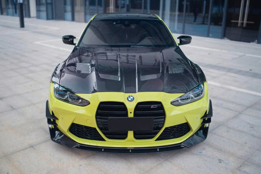 BMW M4 G82 in Sao Paulo Yellow with CMST carbon fibre bonnet and front lip, low front three-quarter hero