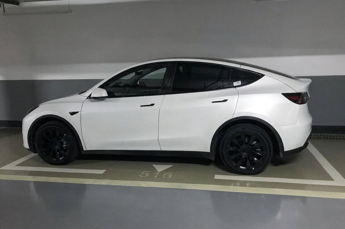 Tesla Model Y in deep red with CMST carbon fibre body kit including bonnet, front lip, side skirts, rear wing and rear lip, low front three-quarter angle