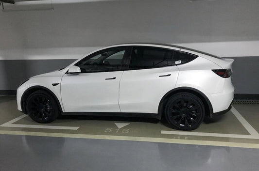 Tesla Model Y in deep red with CMST carbon fibre body kit including bonnet, front lip, side skirts, rear wing and rear lip, low front three-quarter angle