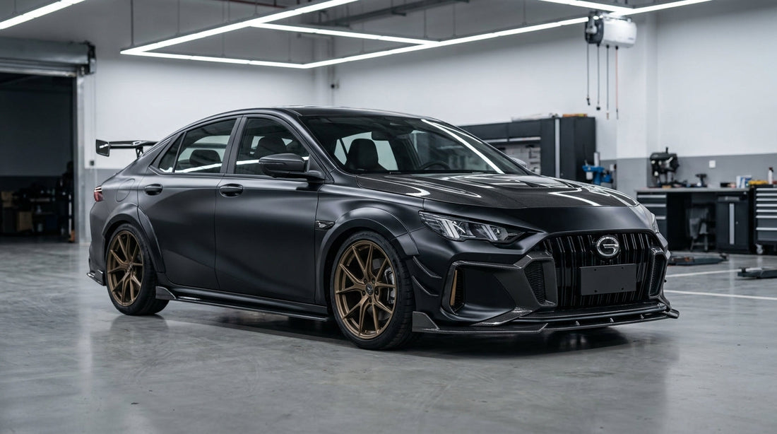 GAC Trumpchi Empow R in matte black wearing the CMST carbon-fibre aero kit, front three-quarter low angle with visible carbon front lip, canards and bonnet
