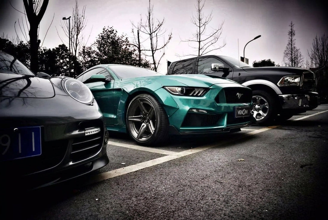 2015-2017 S550 Ford Mustang in deep jade-green metallic wearing the CMST dry-carbon and FRP widebody kit, 3/4 front low angle on 20-inch forged wheels