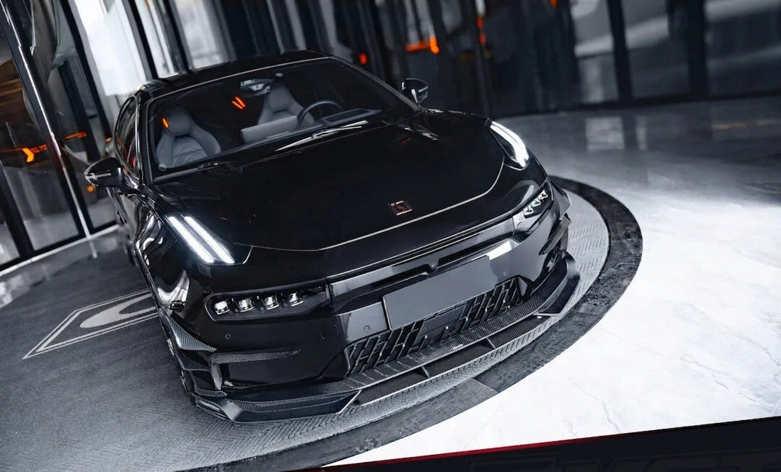 Zeekr 001 shooting-brake in white with CMST gloss carbon front lip and canard-integrated rear lip, low three-quarter front angle, studio lighting