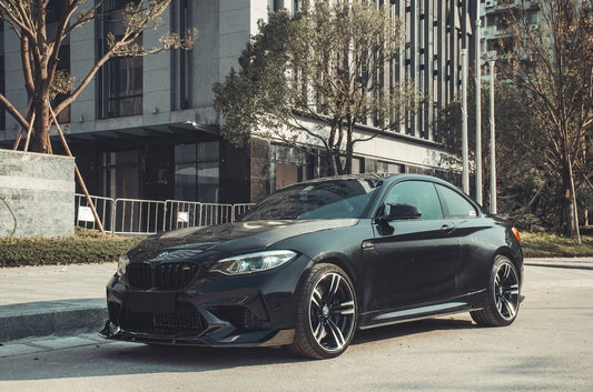 Sapphire Black BMW M2 Competition with full CMST carbon-fibre kit, low front three-quarter studio shot