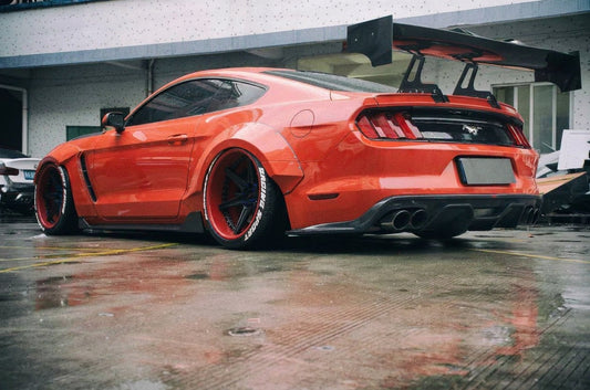 2015-2017 S550 Ford Mustang wearing the CMST D-style carbon bonnet with a clear window and louvred vents, plus a large carbon GT rear wing