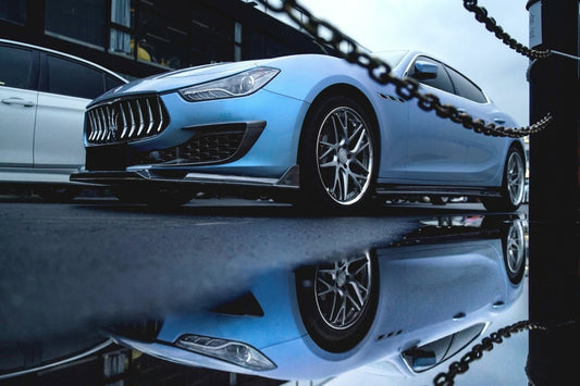 Light blue Maserati Ghibli with CMST carbon-fibre kit and forged wheels, low front three-quarter hero