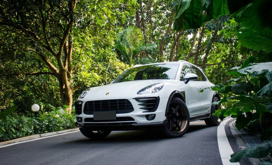 White Porsche Macan S with CMST carbon front lip, side skirts and rear spoiler on forged wheels, low front three-quarter hero
