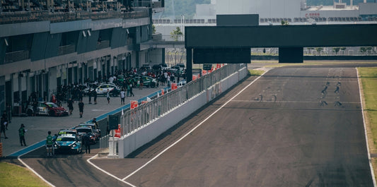 CTCC touring car with full CMST carbon fibre race aero — splitter, dive planes, rear wing — on circuit at speed, dramatic motion blur