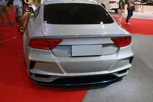 Silver Audi A7 Sportback with CMST carbon bonnet and lips, three-quarter front low angle in a studio