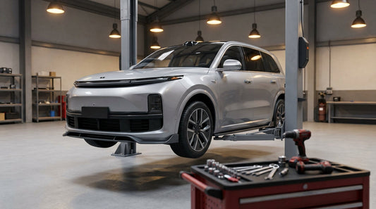 Li Auto MEGA in a clean workshop during body kit fitment, front three-quarter on a hoist