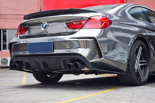 Grey BMW 640i coupe with CMST carbon-fibre quad exhaust tips, low rear three-quarter studio shot