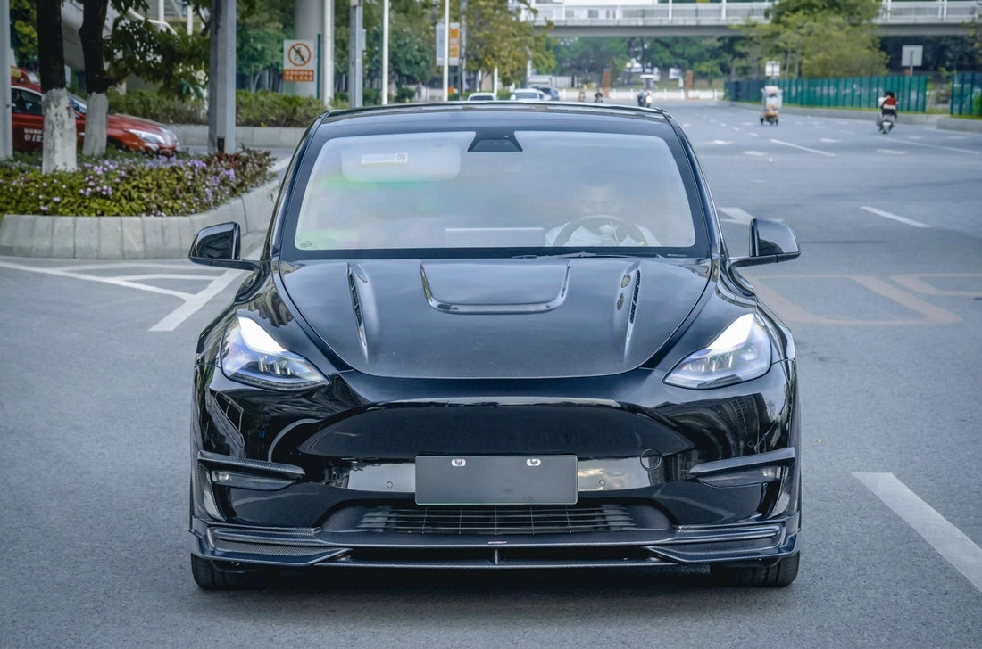 CMST Tesla Model Y carbon fibre full aero kit in white, 3/4 front low angle, dramatic studio lighting