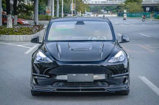 CMST Tesla Model Y carbon fibre full aero kit in white, 3/4 front low angle, dramatic studio lighting