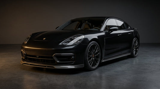 Porsche Panamera 971 in jet black with CMST carbon fibre front lip, vent trims, side skirts and rear lip, 3/4 front low angle in studio lighting