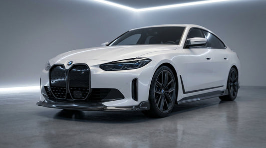 White BMW i4 G26 Gran Coupe with CMST carbon front lip and side skirts, low front three-quarter studio shot
