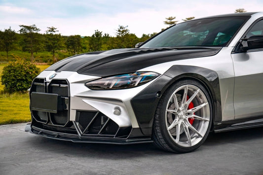 BMW 4 Series G22 in silver with CMST carbon widebody kit and goose-neck wing, low front three-quarter hero