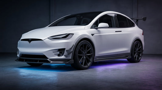CMST Tesla Model X carbon fibre body kit in Pearl White, low front three-quarter angle, dramatic studio lighting