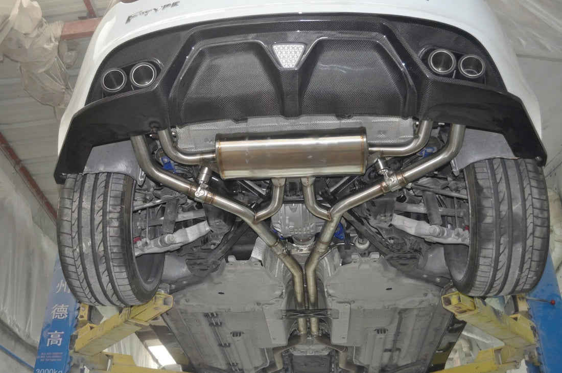 Rear three-quarter of a Jaguar F-Type with CMST valved exhaust and twin carbon-fibre tips exiting the diffuser
