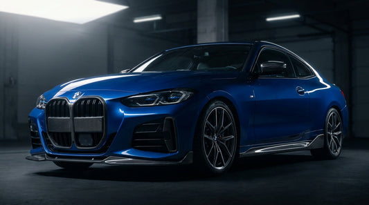 Blue BMW 4 Series G22 coupe with CMST carbon front lip and rear lip, low front three-quarter studio shot