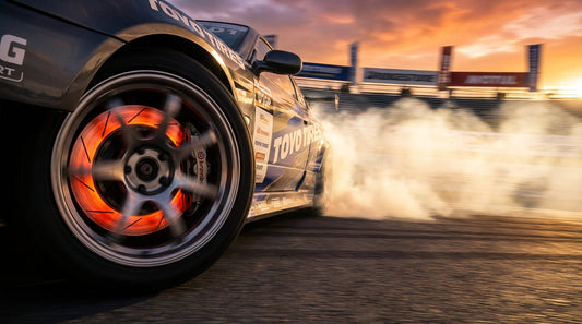 Close-up of a professional drift car's glowing brake rotors and performance calipers during a high-speed drift, illustrating competition-grade braking excellence.