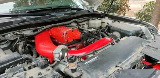 Close-up of the VT-V105 twin-screw supercharger kit installed on a Nissan Patrol Y62 4.0L VQ40 engine, showcasing the performance hardware and integrated cooling system.